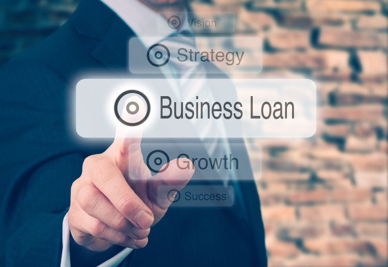 Businessman pressing a Business Loan concept button. Instagram styling applied. Businessman,Pressing,A,Business,Loan,Concept,Button.,Instagram,Styling,Applied.